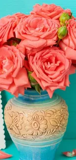 Beautiful coral roses in a decorative vase against a turquoise background.