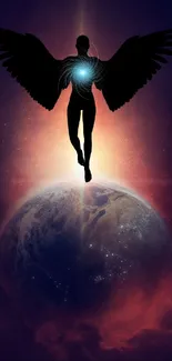 Silhouette of angel with wings and glowing globe on a cosmic background.