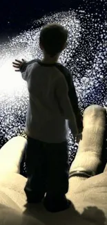 Child reaching out to cosmic galaxy on a hand, beautiful night sky wallpaper.