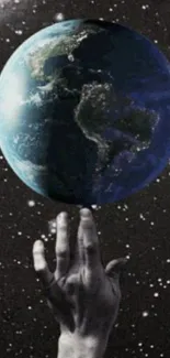 Hand holding Earth in space with stars.