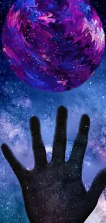 A cosmic hand reaching for a vibrant purple planet in a starry sky wallpaper.