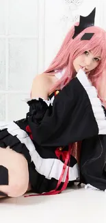 Anime-inspired girl in cosplay costume with pink hair and black outfit.