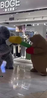 Two costumed bears playfully engage in a mall.