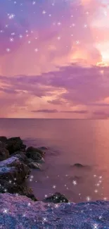 Pink sunset over ocean with rocks and stars shimmering.