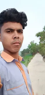 Person on a serene countryside road with lush green surroundings.