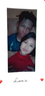 Couple embracing with heart designs on a mobile wallpaper.