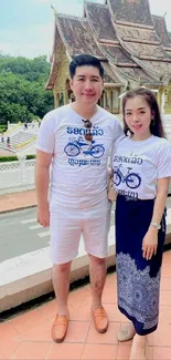 Couple in matching outfits at a historic temple.