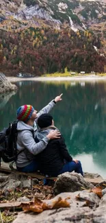 Couple enjoying view by a mountain lake.