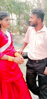 Couple in garden with red dress.