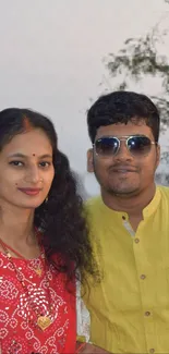 Couple in colorful traditional attire embracing cultural elegance.