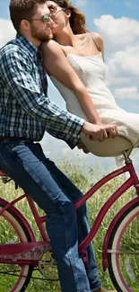 Romantic couple riding a pink bicycle under a blue sky.