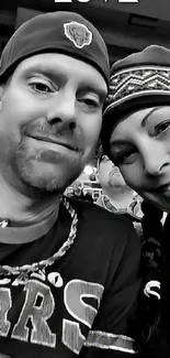 Black and white photo of a smiling couple wearing hats.