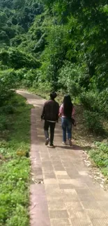 Couple walking along a lush forest path.