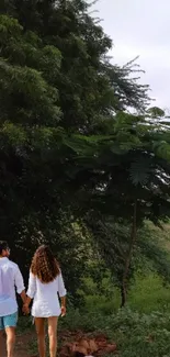 Couple walking amidst lush green trees in a serene landscape scene.