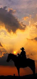 Silhouette of cowboy on horse at sunset with dramatic sky.