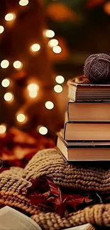 Stack of books with warm fairy lights in autumn setting.