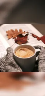 Warm autumn coffee with book and leaves.