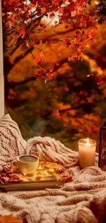 Cozy autumn window with blanket, candles, and leaves.