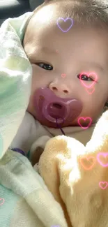 Cute baby with pacifier wrapped in a cozy blanket.