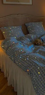 Cozy bedroom setting with twinkling light bedding and a teddy bear on the bed.