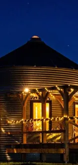 Cabin with glowing lights under a starry night sky.