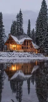 Cozy winter cabin reflected in a serene lake surrounded by snowy trees.