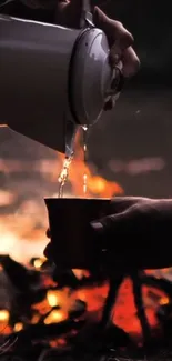 Silhouette of pouring coffee by campfire at dusk.