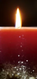 Red candle with glowing flame, ideal for a cozy mobile wallpaper.