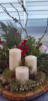 Holiday candles with pine branches on rustic table.