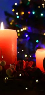 Red Christmas candles with festive lights in the background.