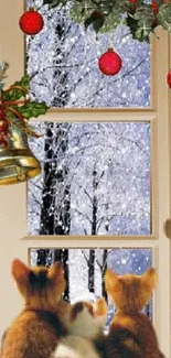 Kittens by a Christmas window with snow and decorations.