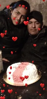 Couple celebrating with a cake on a rustic table.