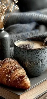 Cozy scene with coffee and croissant on a book.