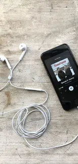 Smartphone, earbuds, and coffee on a wooden table with chocolate bars.