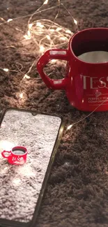 Red mug and smartphone on a cozy carpet lit by fairy lights.