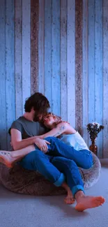 Cozy couple in blue-themed room wallpaper.