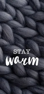 Dark knit texture wallpaper with 'Stay Warm' text.