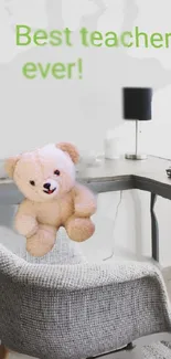 Teddy bear on desk with 'Best teacher ever!' text.