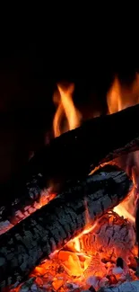 Mobile wallpaper showing a cozy fireplace with glowing embers and flames.