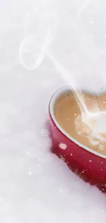 Heart-shaped red mug with steaming coffee on white background.