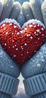 Knitted red heart held in cozy winter gloves.