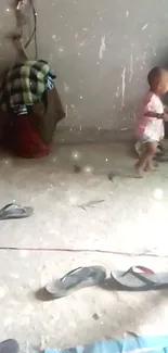 Toddler playing on a gray floor with items around.