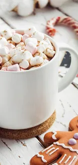 Warm hot chocolate in a mug with marshmallows and a gingerbread cookie.