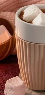 Warm cup of cocoa with pink and white marshmallows.