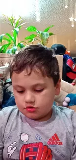 Child in a cozy room surrounded by toys and plants.