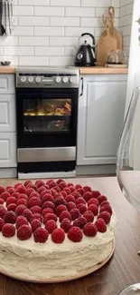 Cozy kitchen with a raspberry cake in the foreground.