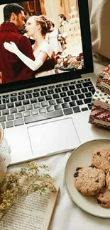 Cozy laptop scene with cookies and tea.