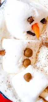 Marshmallow snowman floats in creamy cocoa.
