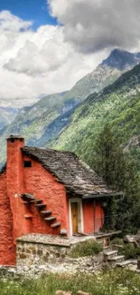 Cozy red cabin amidst lush mountains and sky