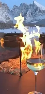 Cozy fireplace with mountain view and a glass of wine.